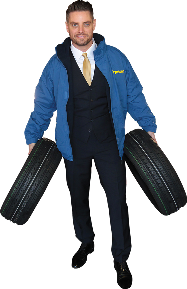 Tyreland team member holding tyres